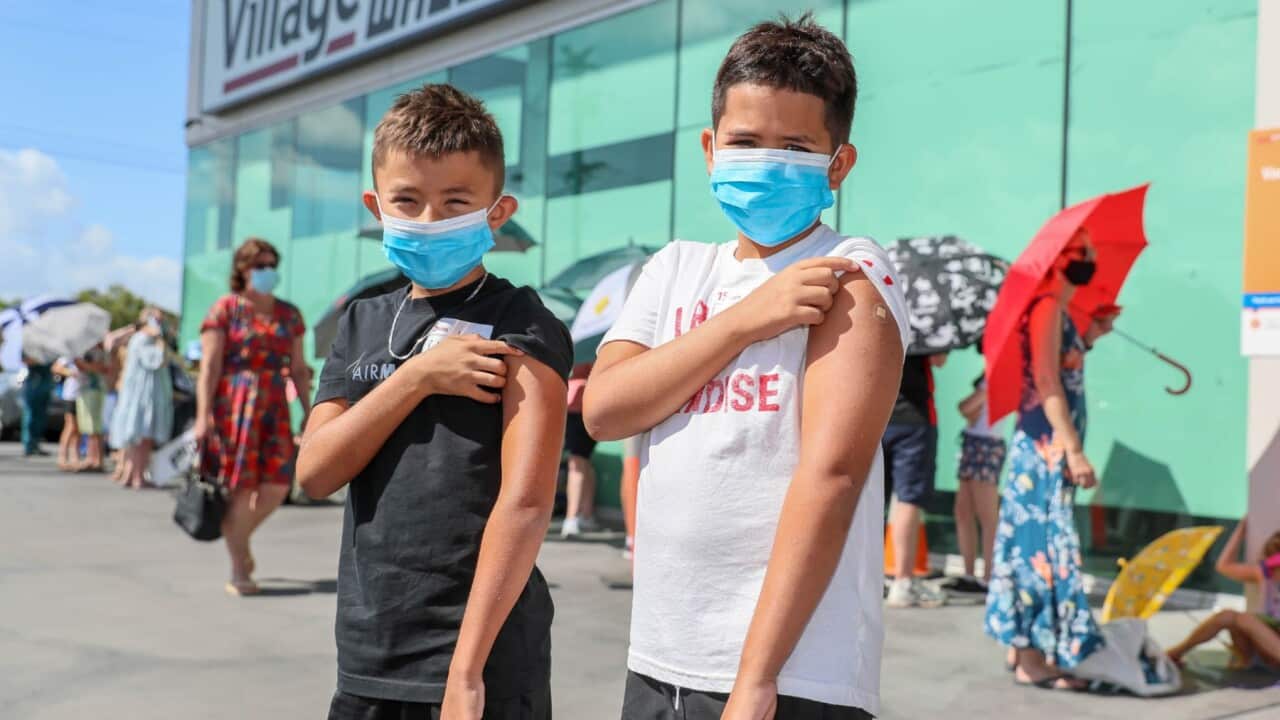 January 10, 2022. Brothers Louise and Harry Taylor-Bishop pose after receiving their first vaccine at Kippa Ring Communication Vaccination Clinic, Brisbane.