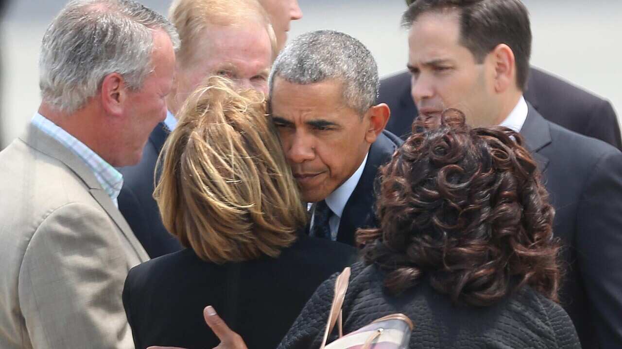 President Barack Obama hugs Orange County Mayor Teresa Jacobs upon the president's arrival at Orlando International Airport