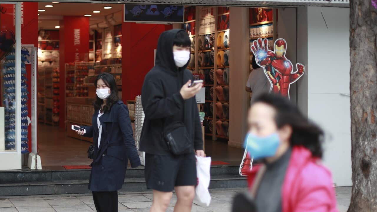 People walk out from a shop in Hanoi, Vietnam Thursday, April 23, 2020.