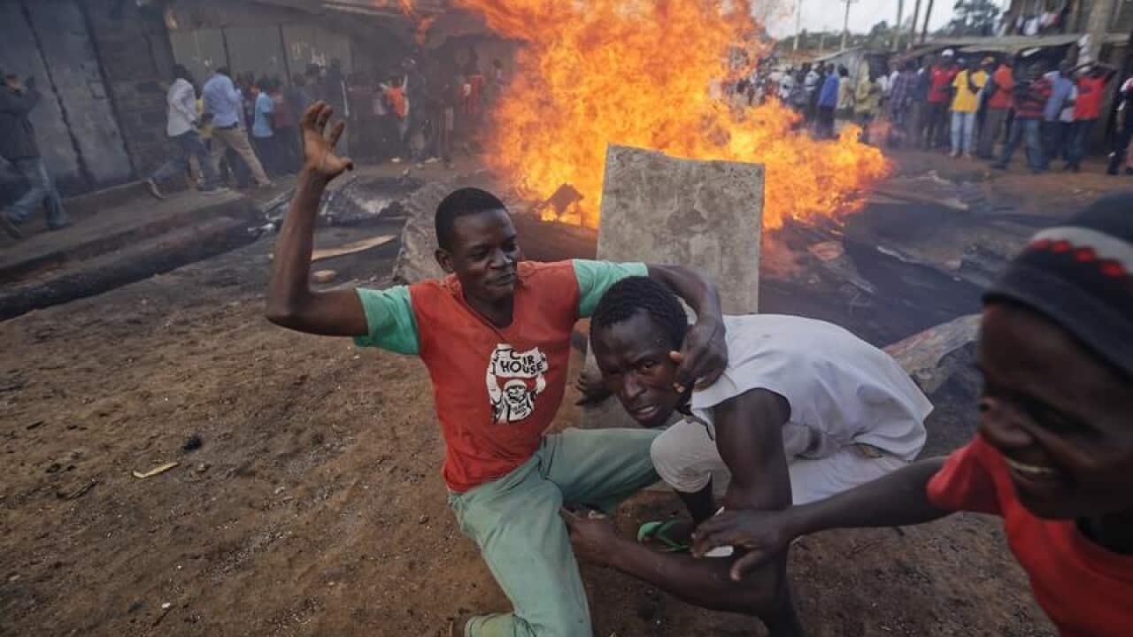 Kenyan opposition supporters move away from a fire in a Nairobi slum.