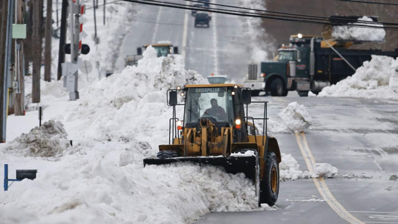 A front loader clears snow in Orchard Park, New York