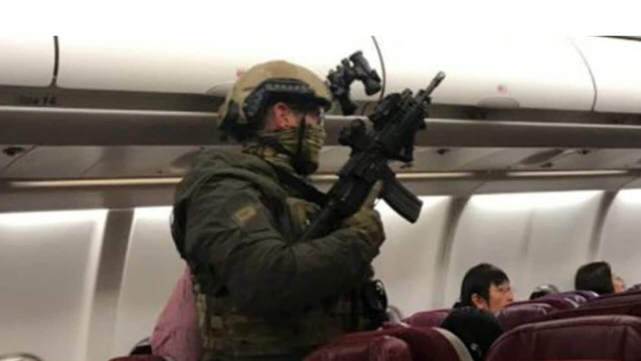 Police on the Malaysia Airlines flight after the bomb scare