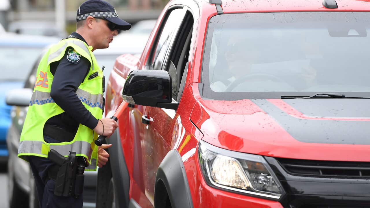 Police check permits at Griffith Street checkpoint at Coolangatta on the Gold Coast.