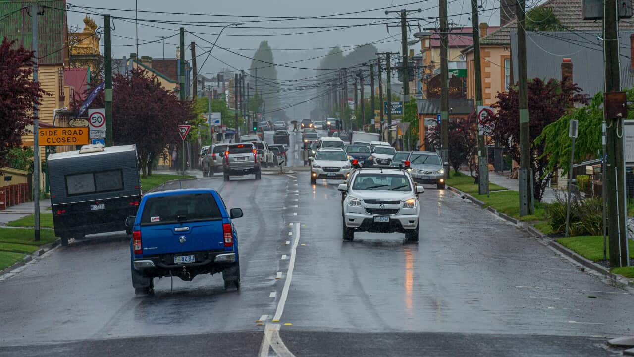 Cars drive down Gilbert Street in Latrobe, Tasmania, Thursday, October 13, 2022. Heavy rain that began on Wednesday night is expected to continue into Friday morning across the northern half of the island state.