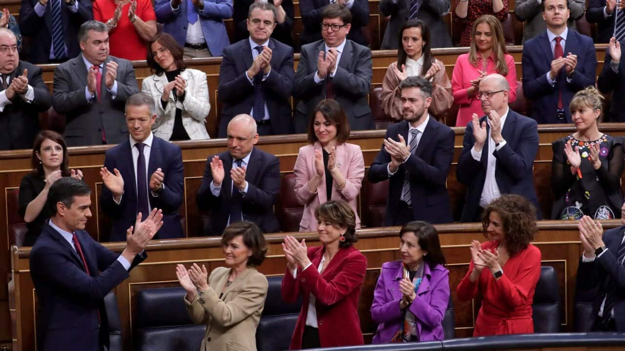 Spain's caretaker Prime Minister Pedro Sanchez, left, applauds with members of the Socialist party at the Spanish parliament in Madrid Tuesday, Jan. 7, 2020.