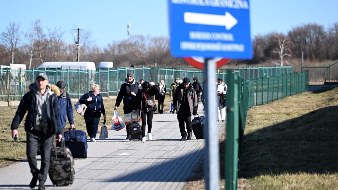 People walk near the Polish-Ukrainian border crossing in Medyka, Poland