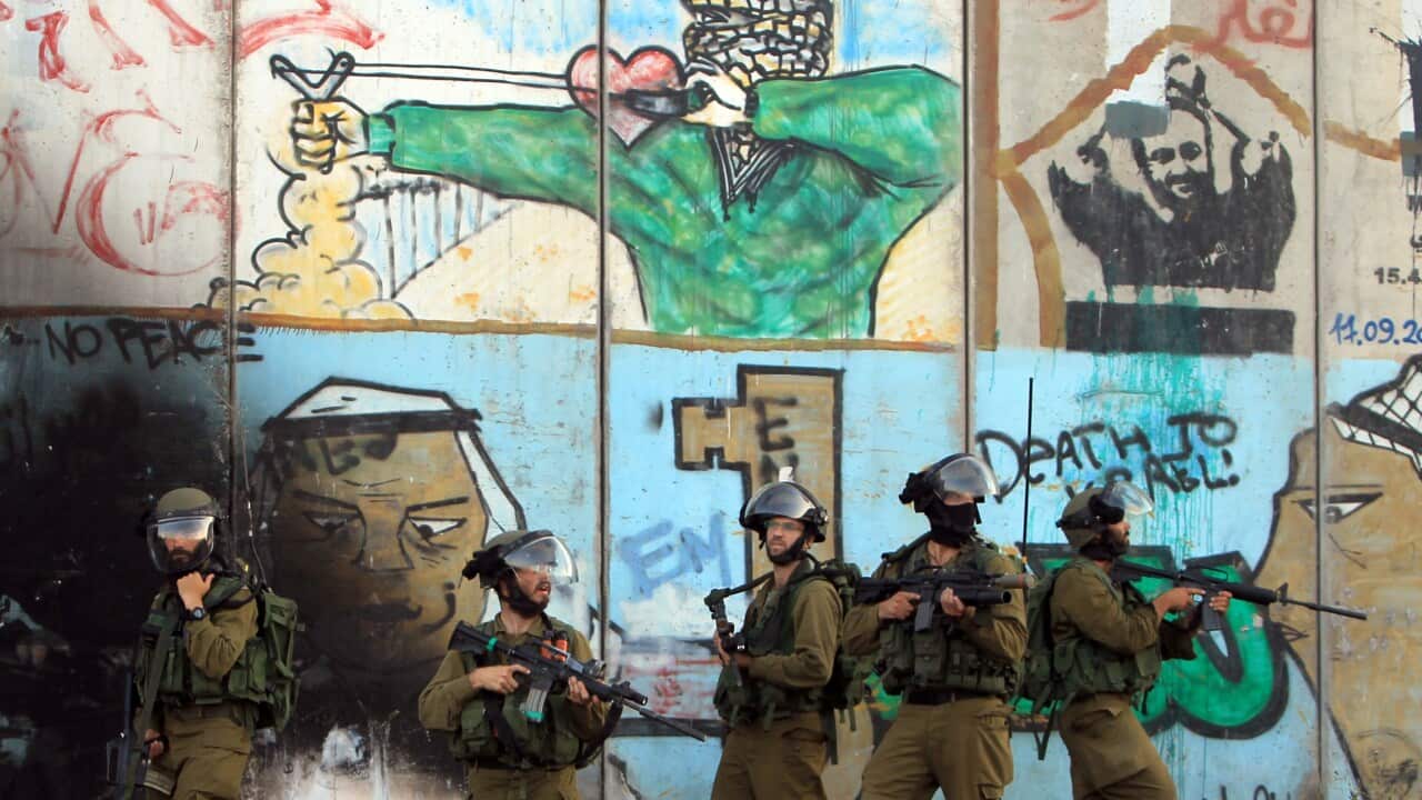 israeli_soldiers_at_the_checkpoint_between_the_west_back_city_of_ramallah_and_jerusalem_getty_images.jpg