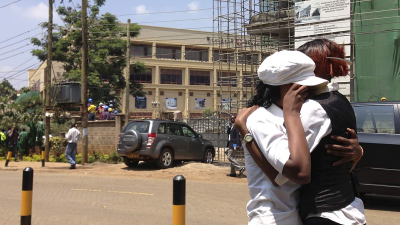 Two women outside a shopping mall in Nairobi after shooting erupted