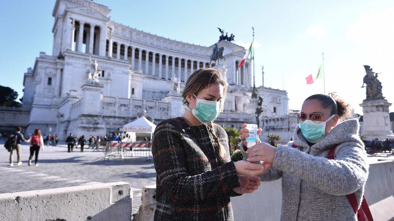 People wearing protective masks in Rome, Italy.