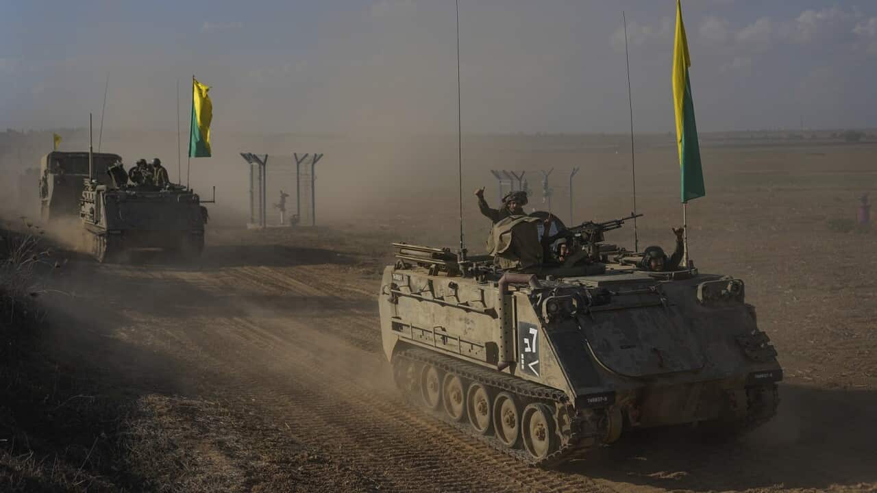 Israeli armored personnel carriers head toward the border with the Gaza Strip in southern Israel