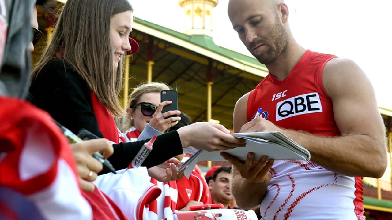 Sydney AFL player Jarrad McVeigh signs autographs for fans