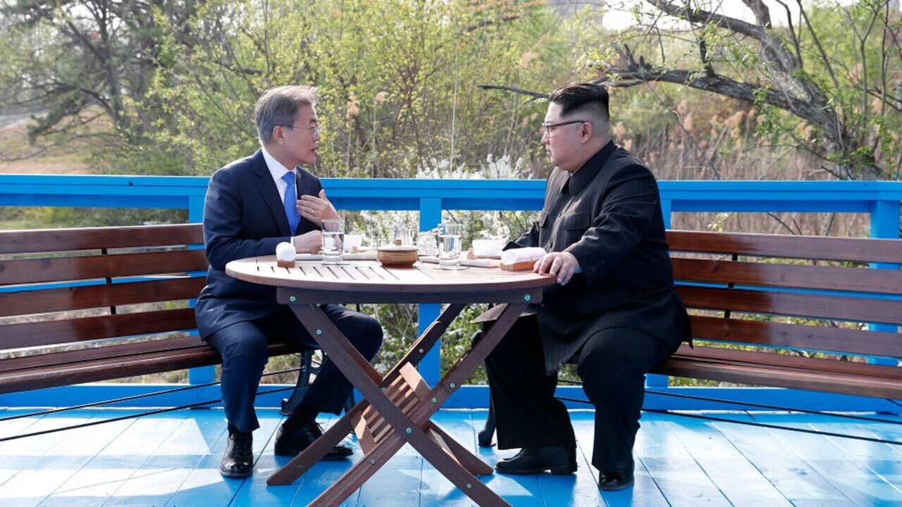 North Korean leader Kim Jong Un (R) and South Korean President Moon Jae-in (L) talk in private during the Inter-Korean Summit on April 27, 2018.