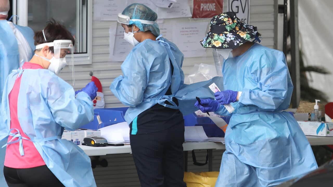Health workers at a COVID-19 testing site in Brisbane on 7 January 2022.
