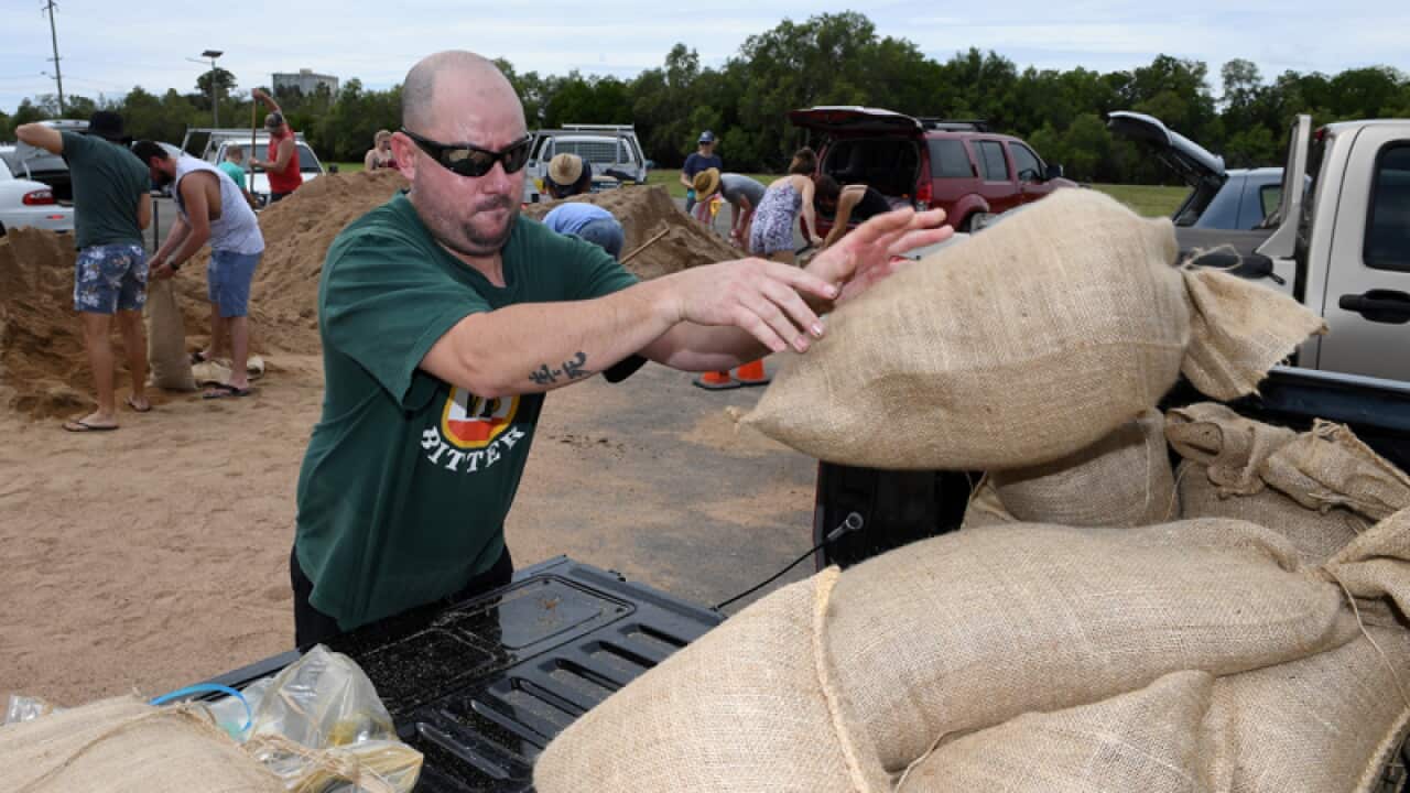Locals fill up sandbags in preparation for Cyclone Debbie