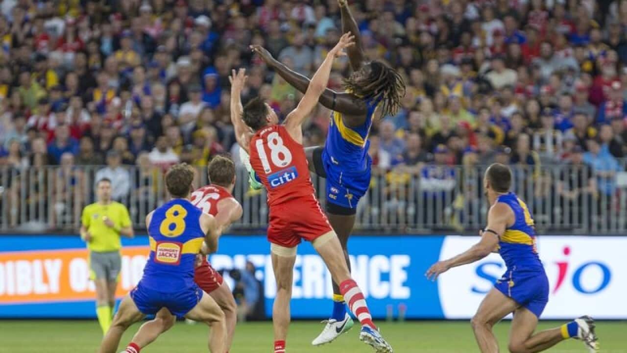 West Coast's Nic Naitanui outrucks Sydney's Callum Sinclair.