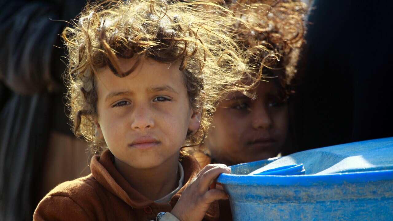 An Iraqi child stands in a camp in the southern desert of Samawa.