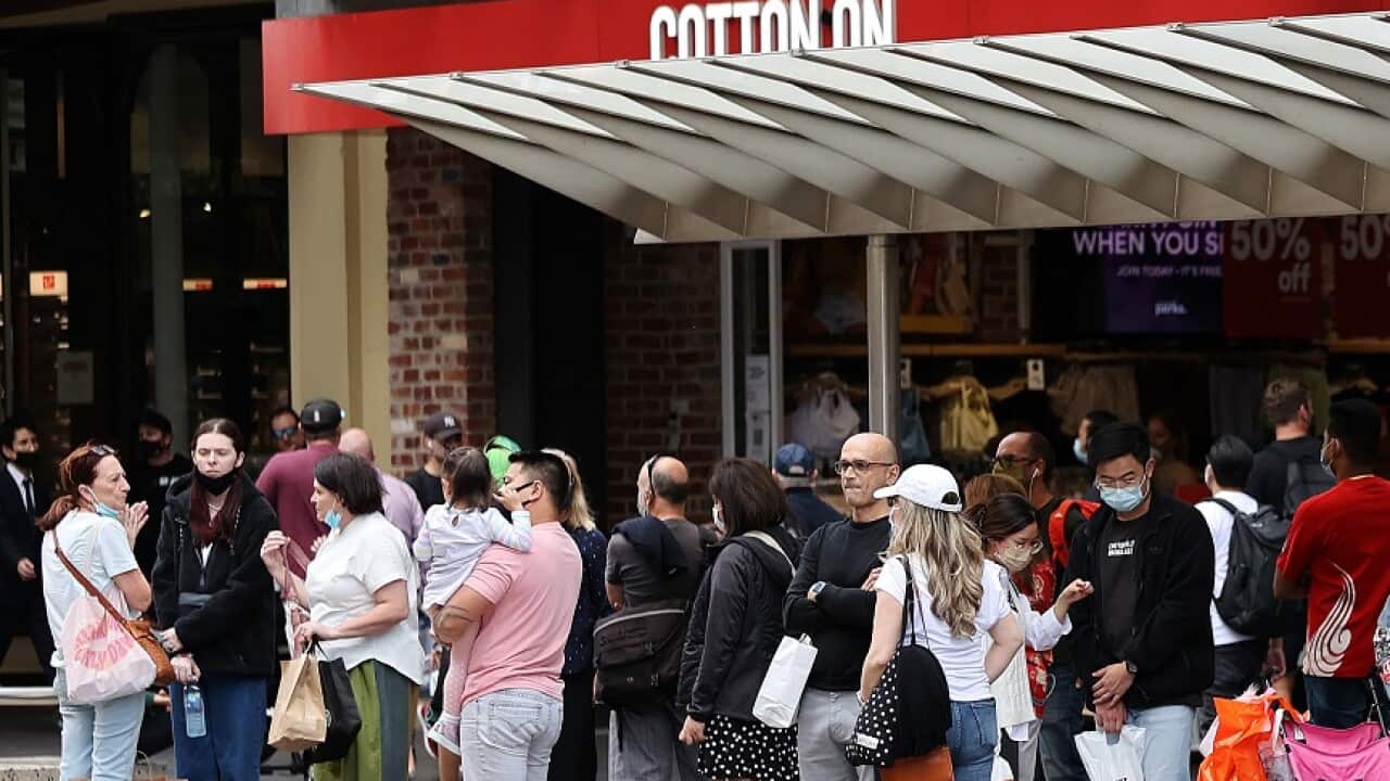 People are seen at a tram stop in Melbourne, Monday, December 27, 2021.