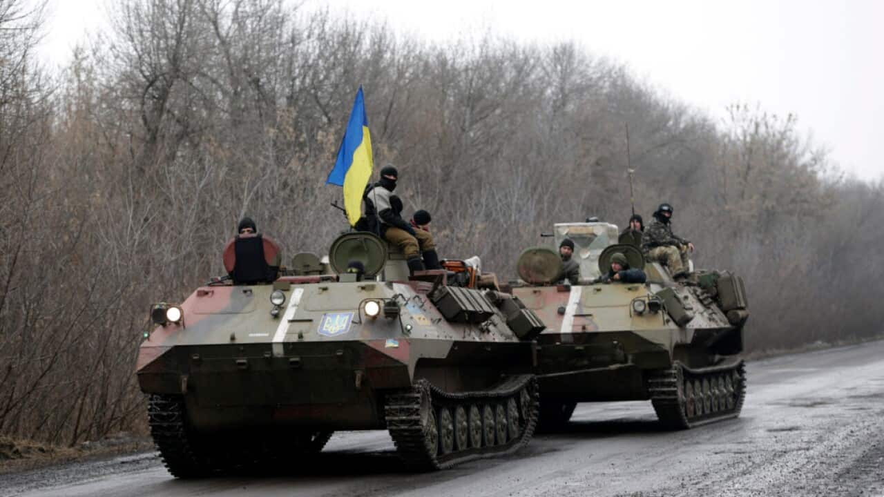 A Ukranian armored vehicle is towed on the road towards the town of Artemivsk, Ukraine (AAP)