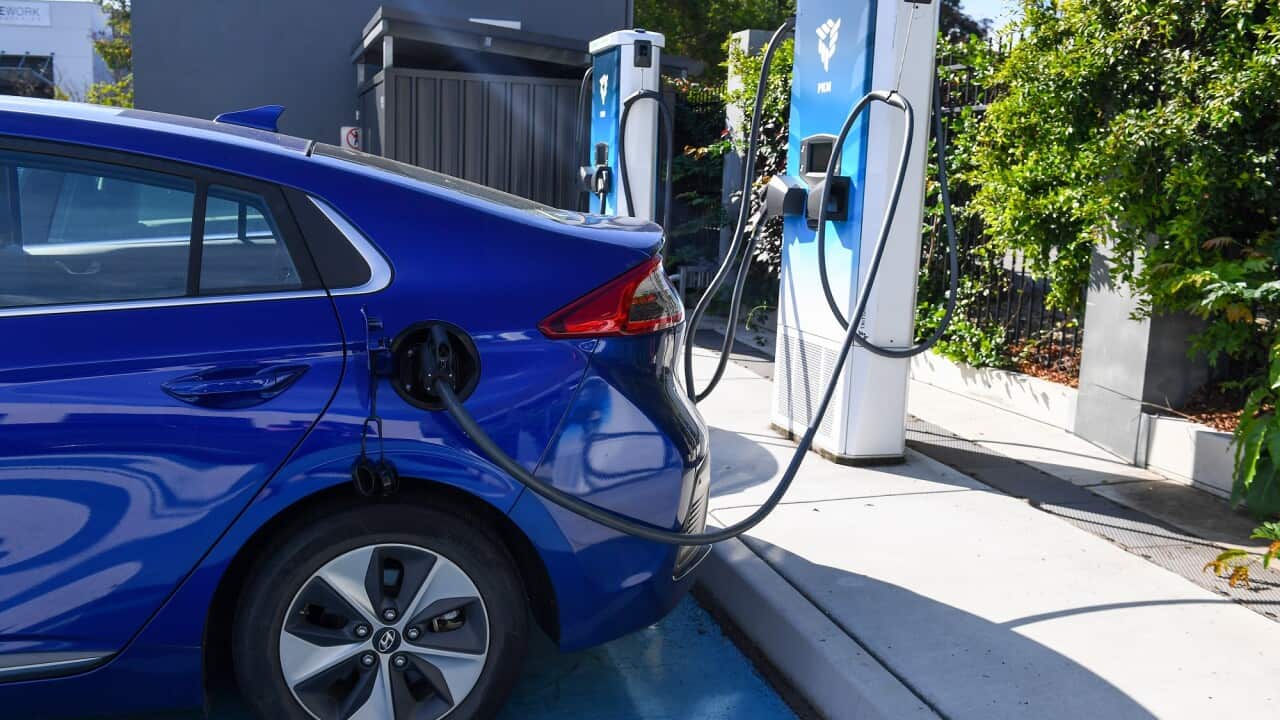 An electric car is plugged into a charging station in Brisbane.
