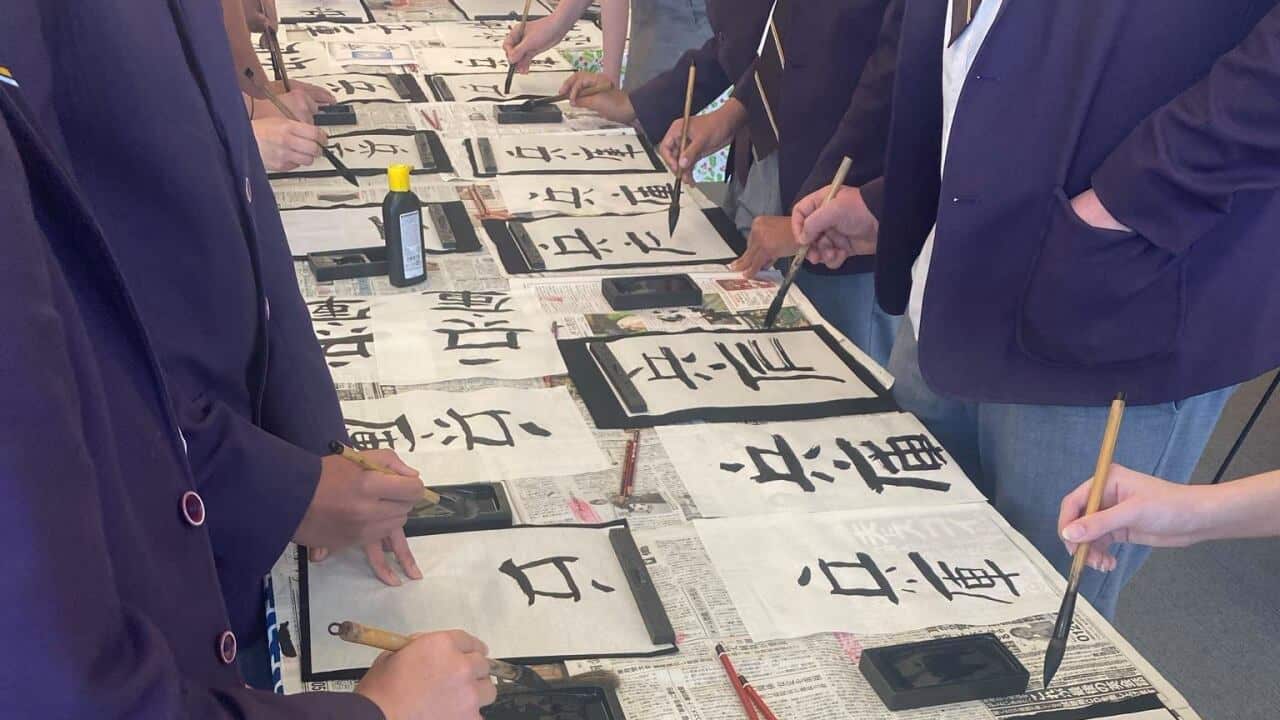 Students are trying Japanese calligraphy at the Hyogo Cultural Center in Perth.