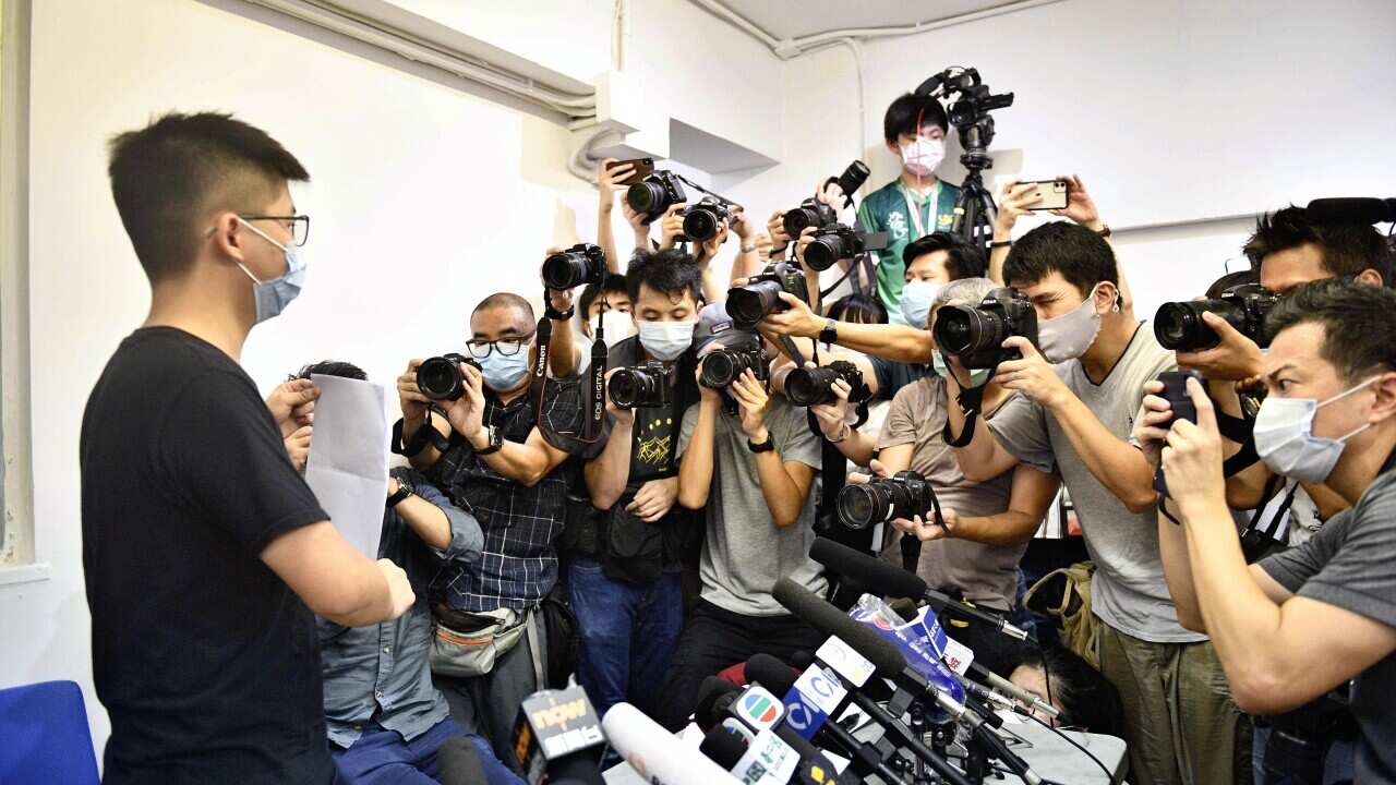 Journalists attend a press conference with Joshua Wong in Hong Kong.