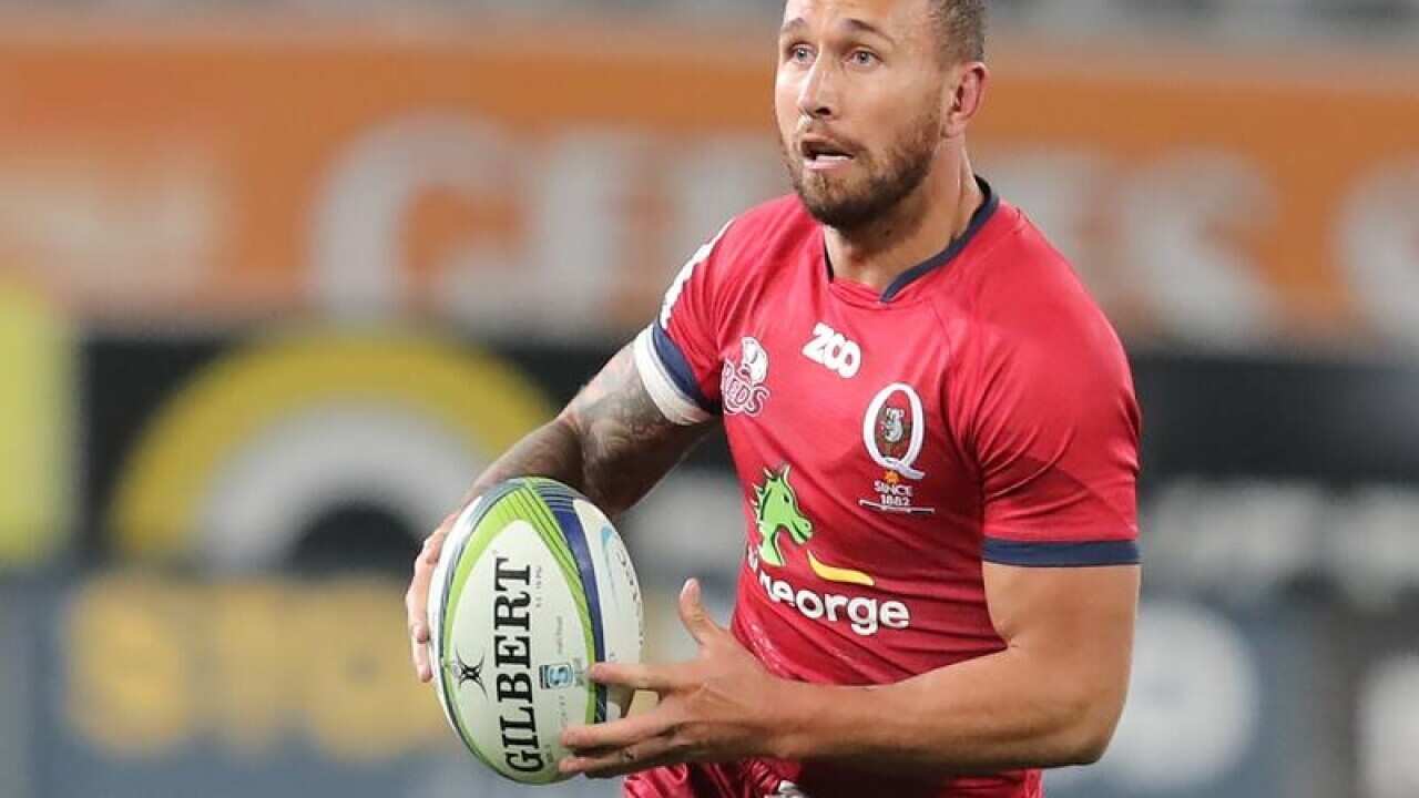 Quade Cooper of the Reds makes a run