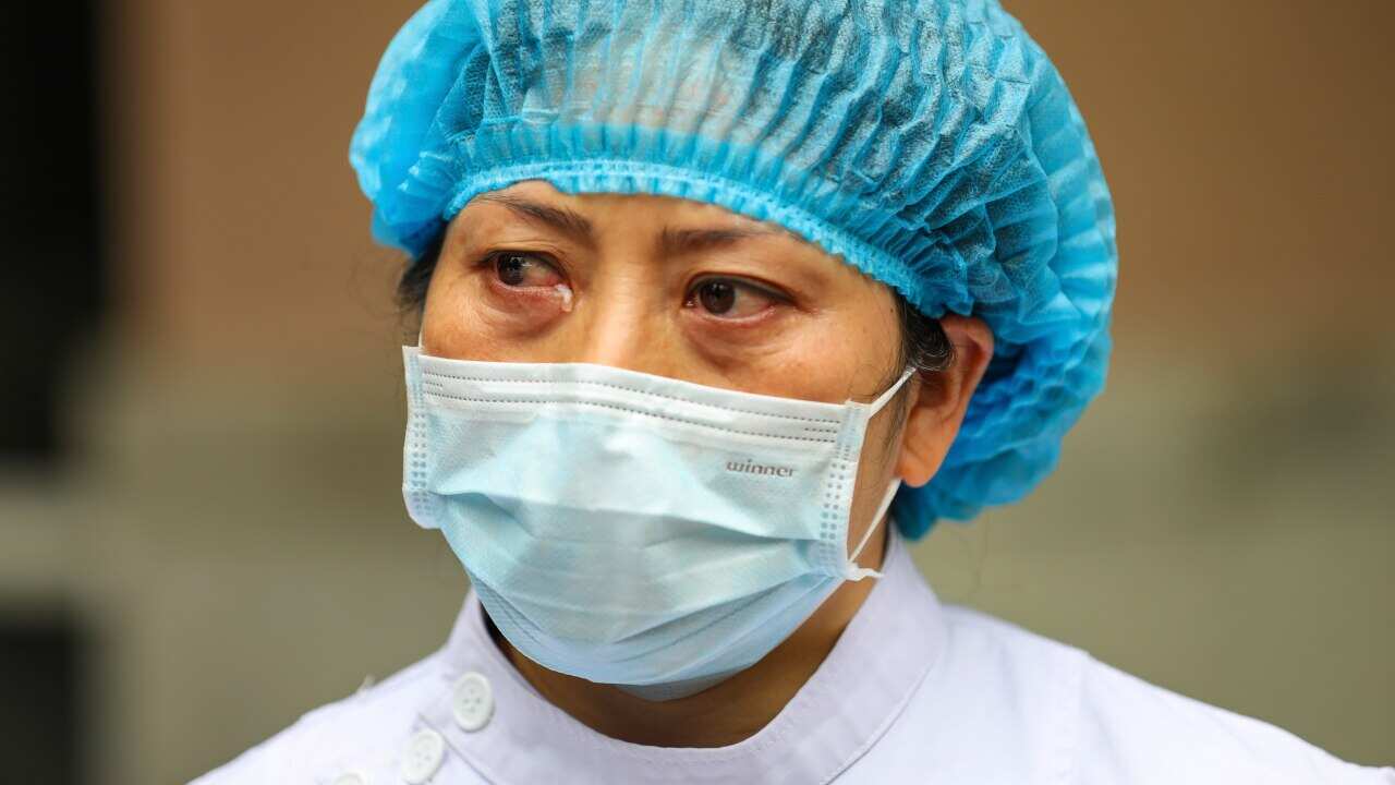 A nurse tears up as she talks about the situation in Jinyintan Hospital, designated for critical coronavirus patients in Wuhan
