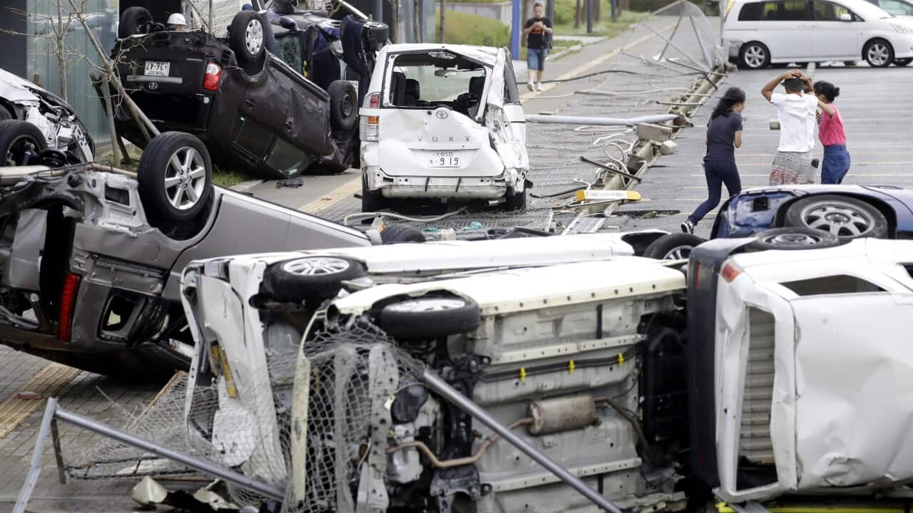 Overturned cars are seen on street following a powerful typhoon in Osaka, western Japan, Tuesday, Sept. 4, 2018.