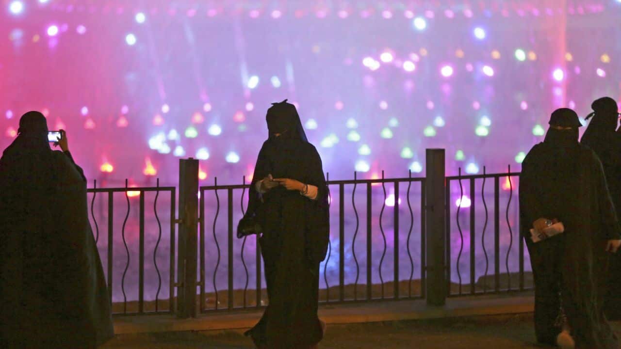 A Saudi woman takes photographs in Riyadh, Saudi Arabia.