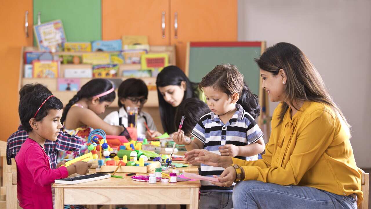 Children with teacher in art class