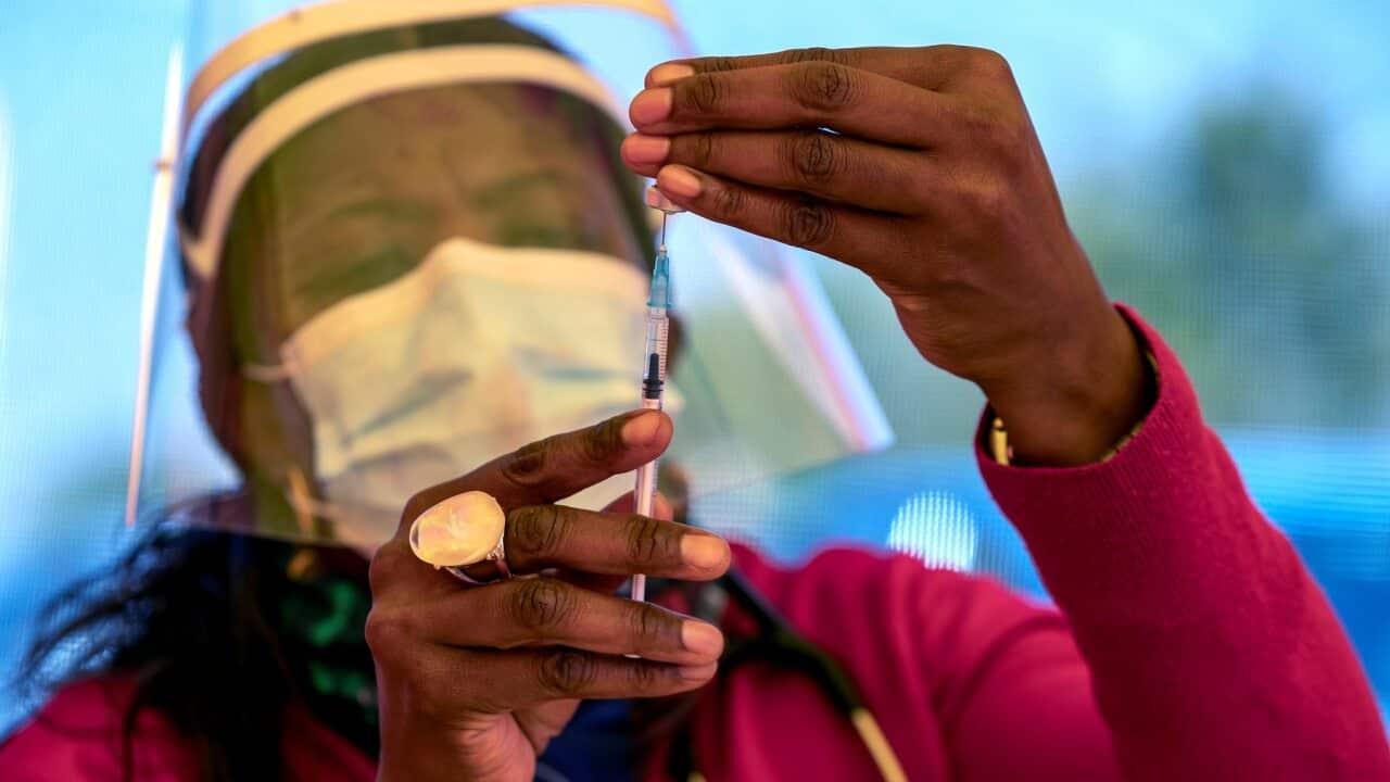 A health worker prepares a dose of vaccine at a mass vaccination centre in South Africa