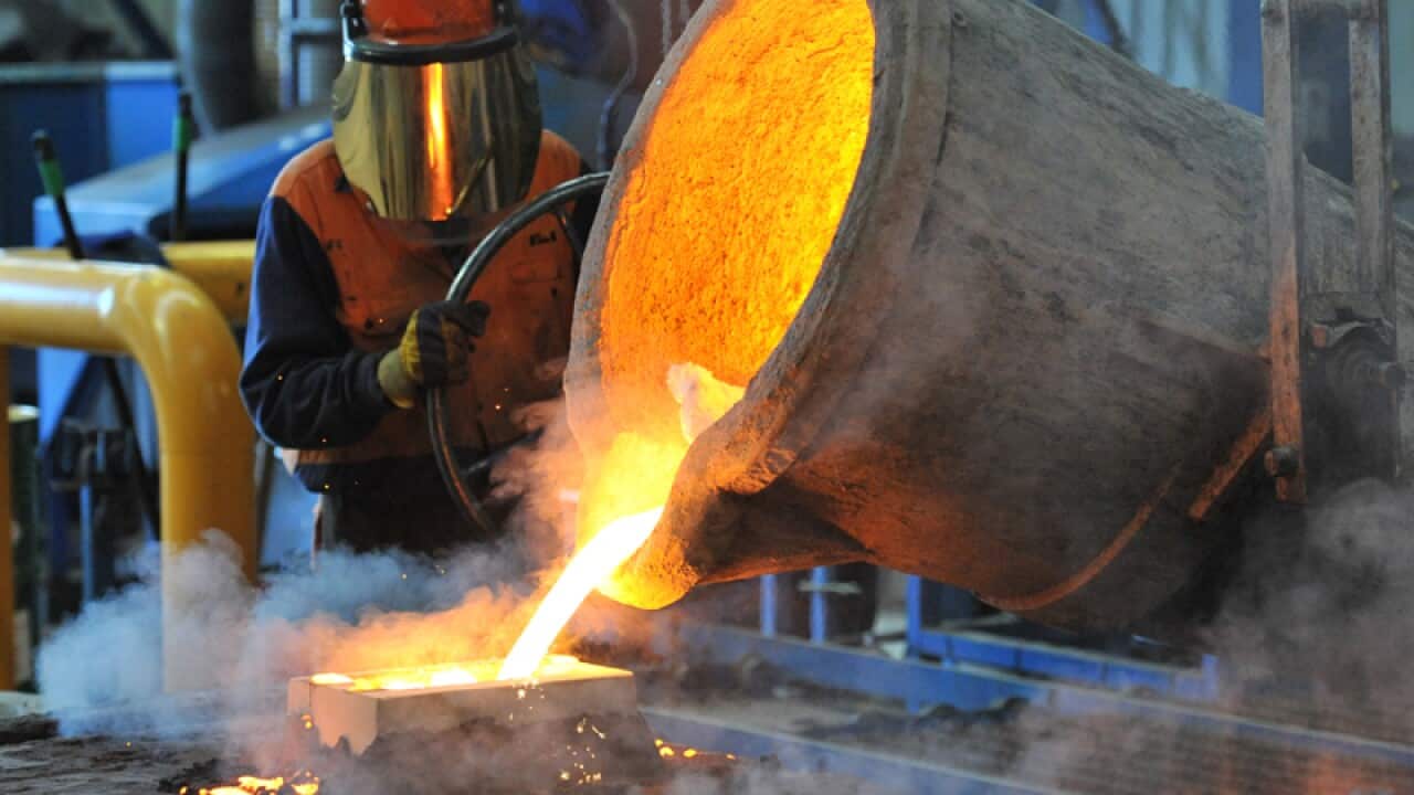 A factory worker pours molten iron at Blackwell IXL