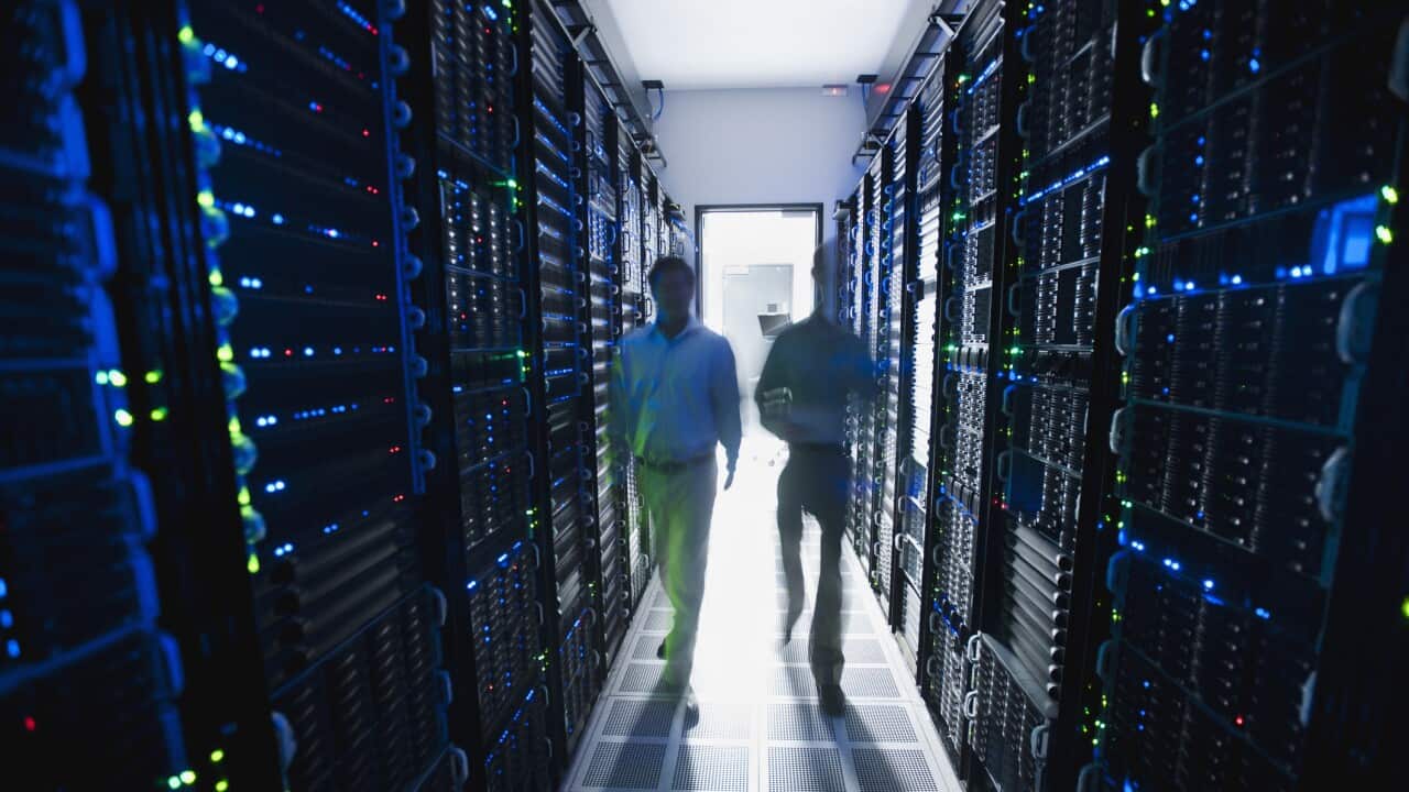 Businessmen walking in server room