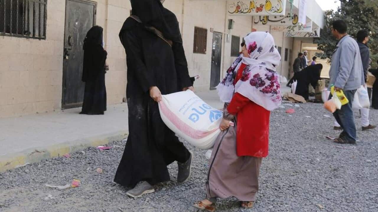 Conflict-affected Yemenis receive food rations.