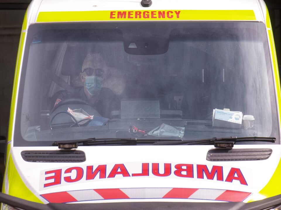 Paramedics tending to their ambulance outside St. Vincent hospital in Melbourne.