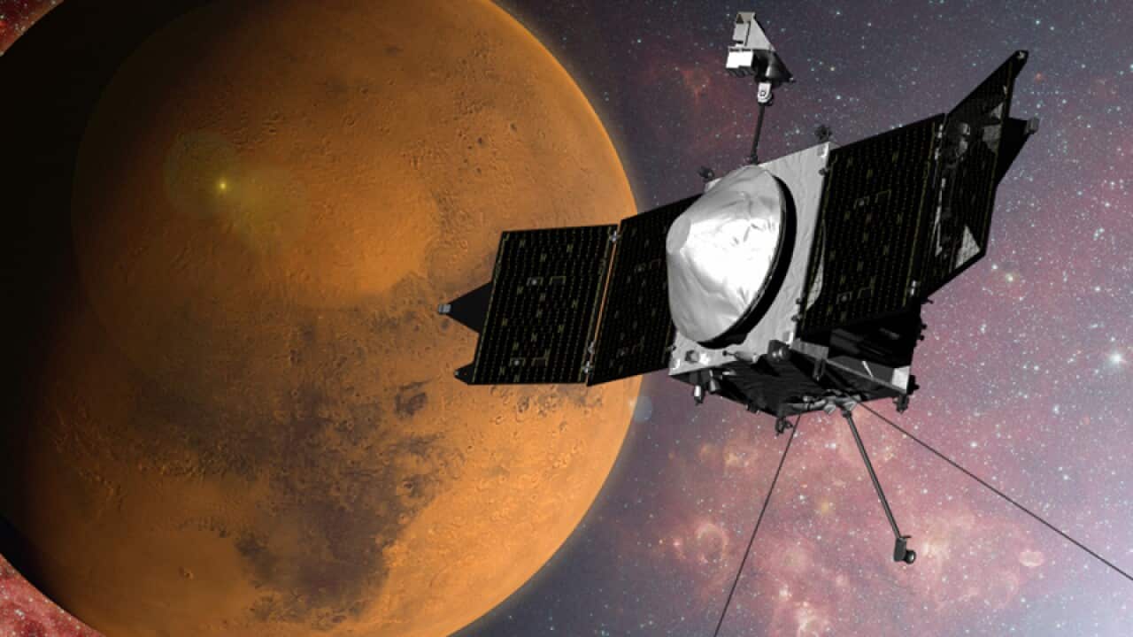 An artist concept of the MAVEN spacecraft approaching Mars