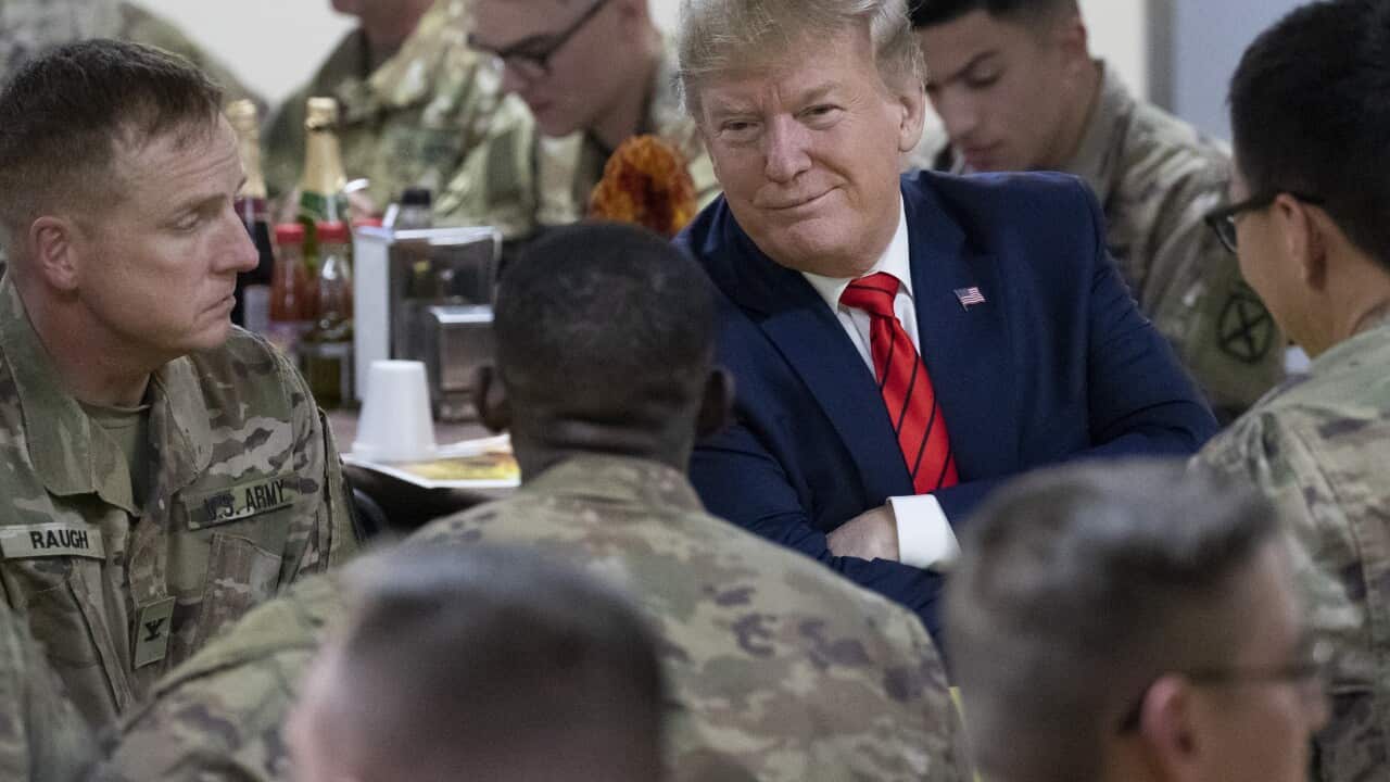 President Donald Trump smiles while sitting with the troops during a surprise Thanksgiving Day visit to Afghanistan, 28 November, 2019.