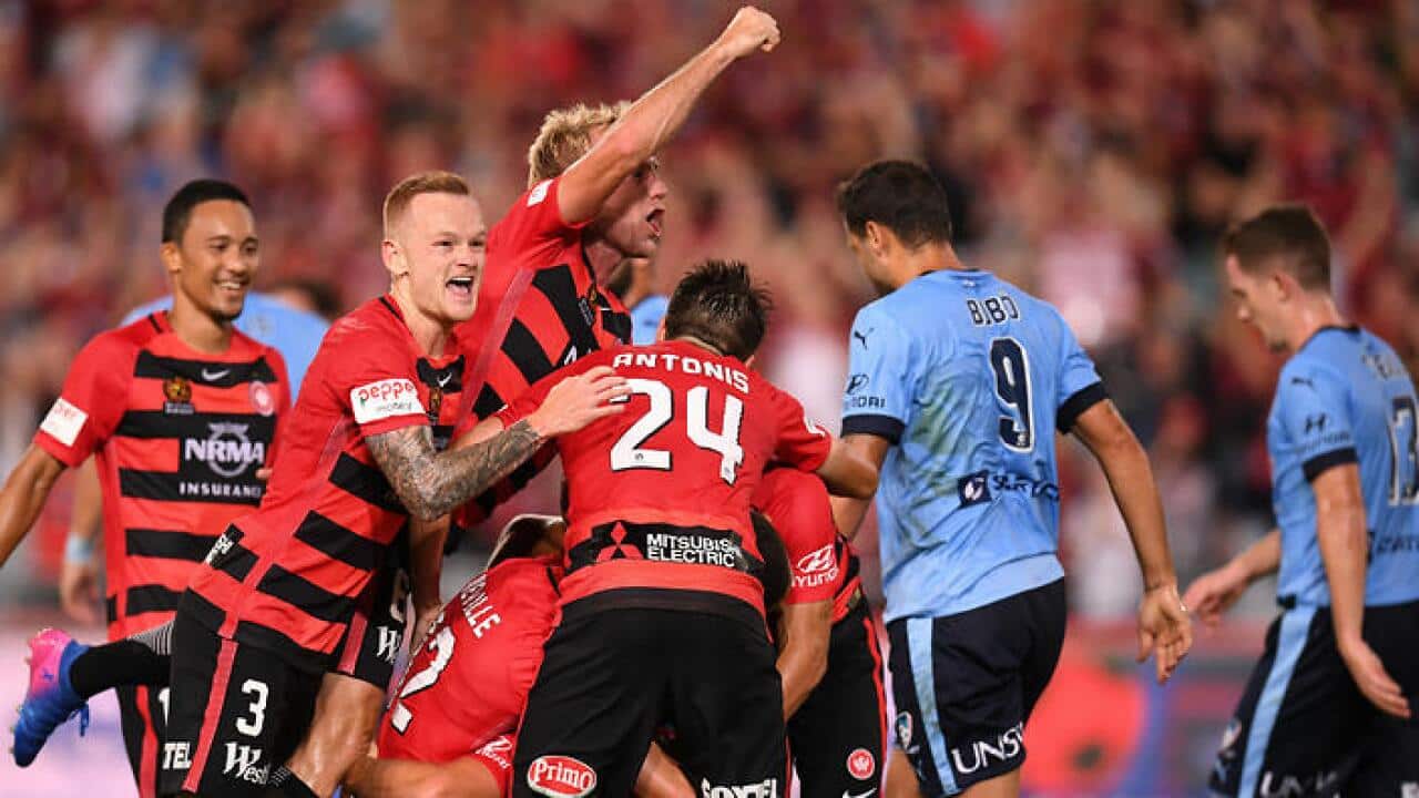 Wanderers players celebrate after scoring against Sydney FC