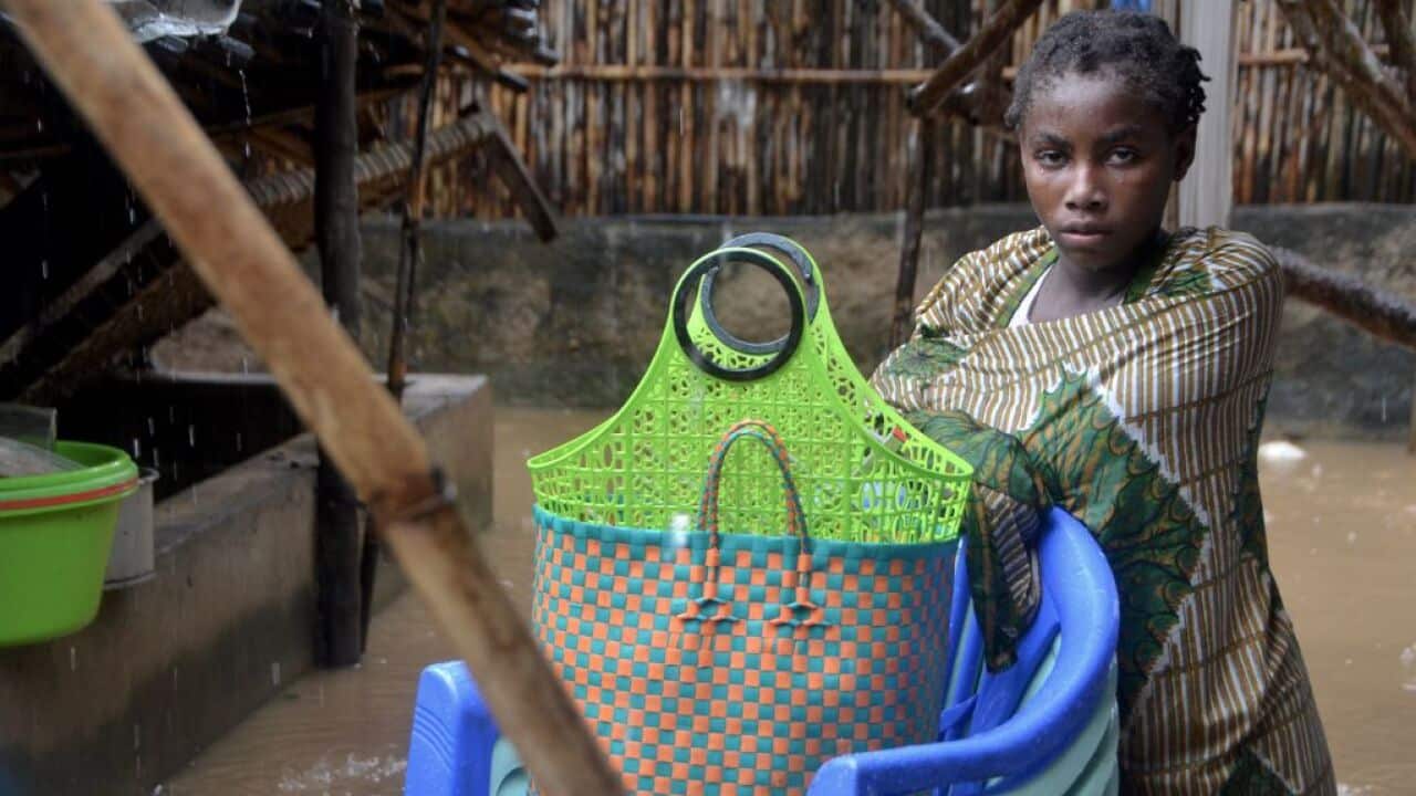 A girl stands next to her belongings in the Paquite district of Pemba following Cyclone Kenneth.