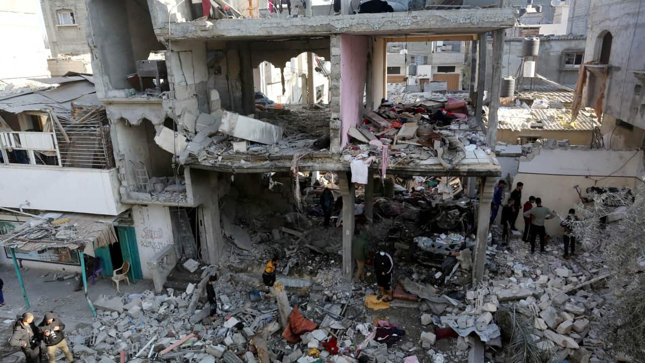 Residents searching for belongings in rubble