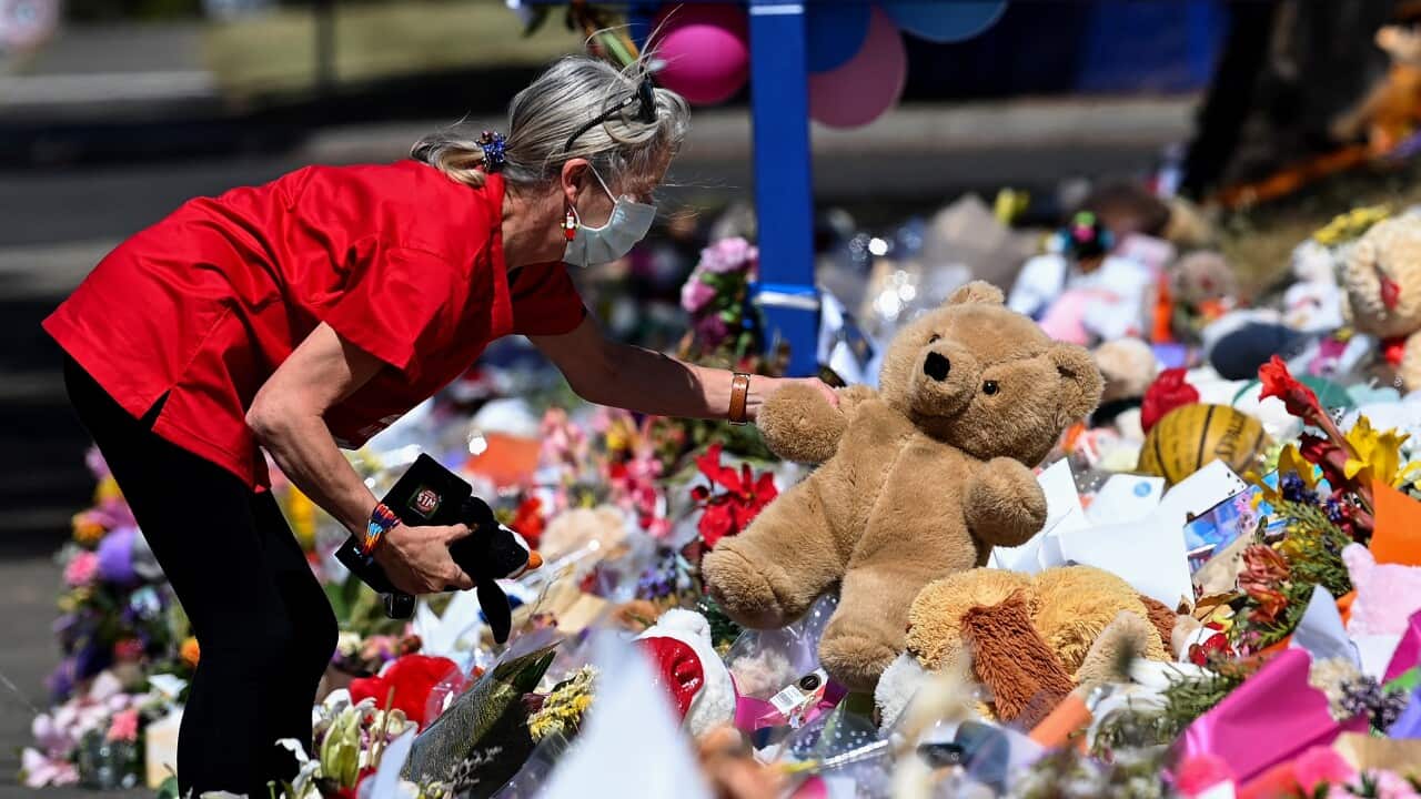 A member of the public pays their respect outside Hillcrest Primary School in Devonport