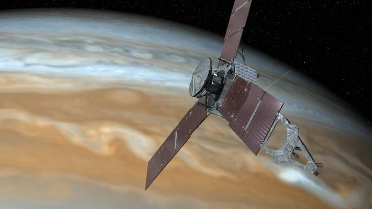 An artist's rendering of NASA's Juno spacecraft passing over Jupiter