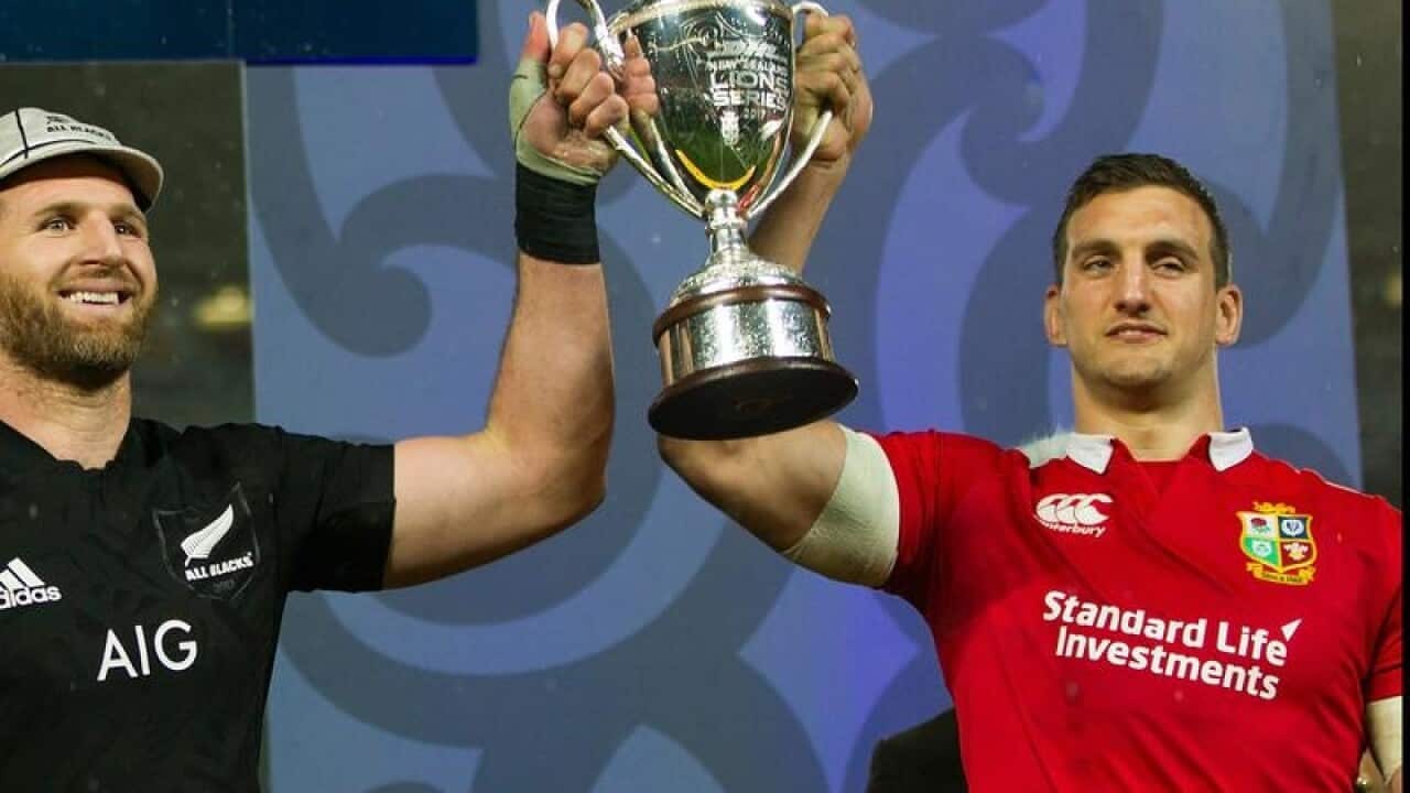 Kieran Read and Sam Warburton of the Lions share the trophy