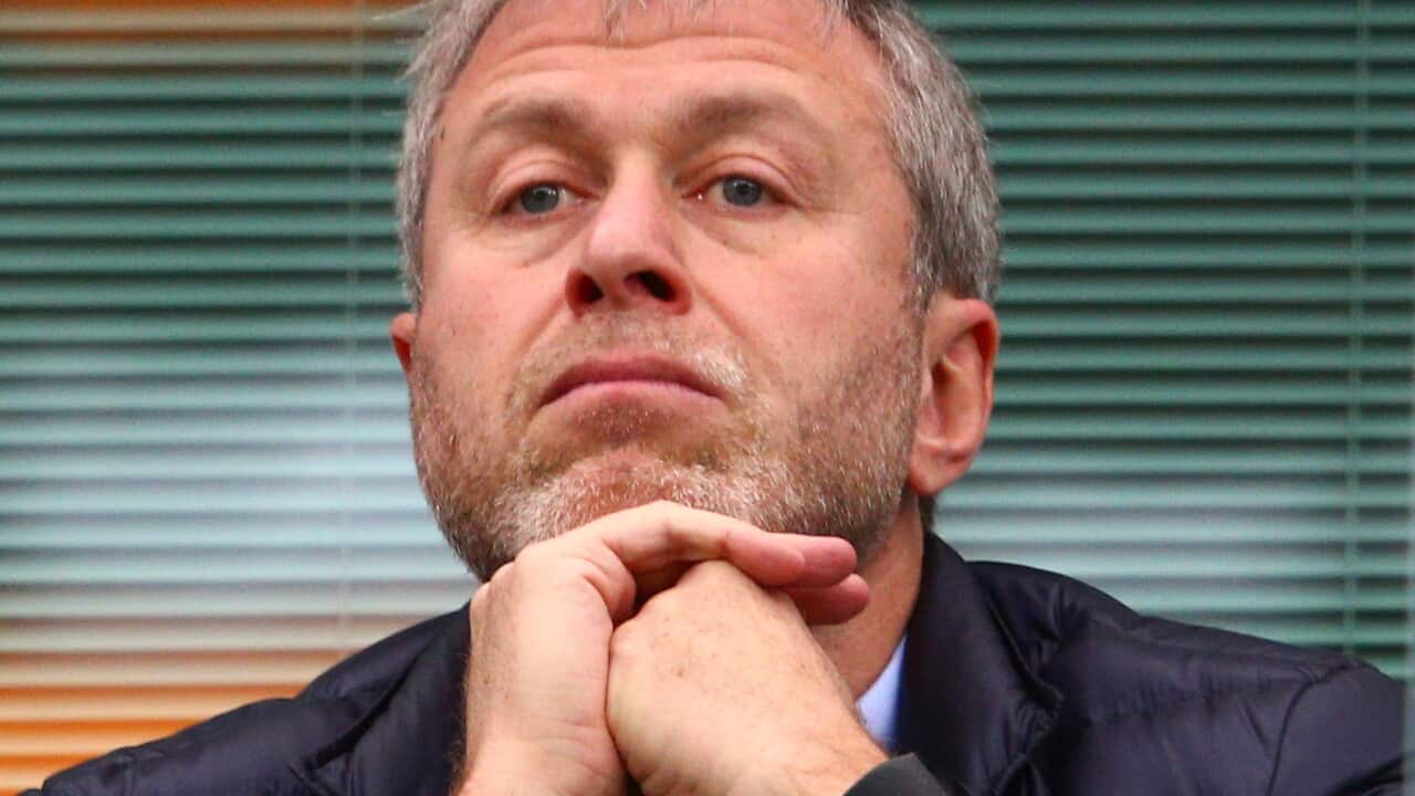 A man resting his chin on his hands.