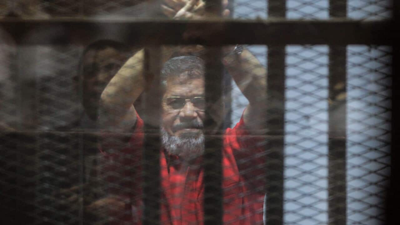 Ousted Egyptian President Mohamed Morsi looks on during a trial session on charges of espionage in Cairo, Egypt