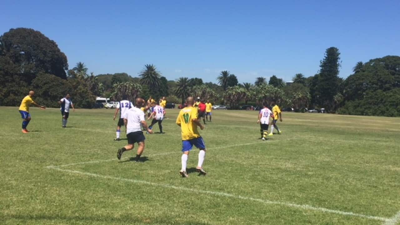 Footballers take part in the 2018 Les Murray Cup at Brazilian Fields in Sydney's Centennial Park.