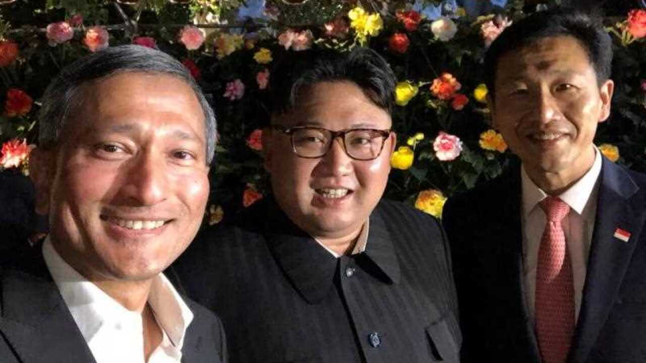 Singapore's Foreign Minister Vivian Balakrishnan (L) via Twitter shows him posing for a selfie with North Korean leader Kim Jong-un (C) and Singapore's Education Minister Ong Ye Kung (R).
