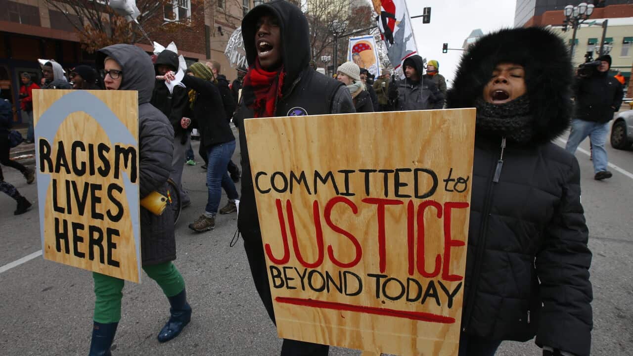 Protesters march down the streets in Clayton, Missouri, USA, 17 November 2014 as people wait for the Grand Jury verdict over the police shooting of an unarmed black teenager in Ferguson, Missouri. (EPA/LARRY W. SMITH)