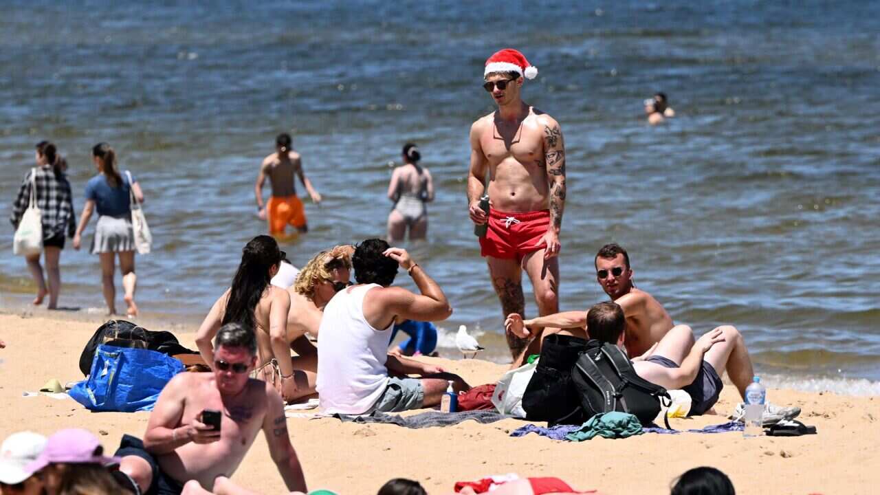 People celebrate Christmas at St Kilda Beach in Melbourne, Sunday, December 25, 2022.