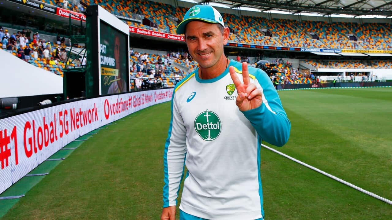 Australian coach Justin Langer gestures after winning the first Ashes cricket test against England at the Gabba in Brisbane, Australia, on Dec. 11, 2021. Langer has resigned as coach of the Australian men's cricket team less than a month after leading the